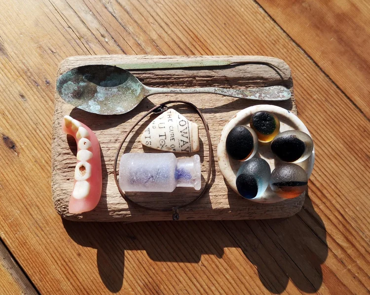 Beachcombing find: a collection of found objects arranged on a wooden tray