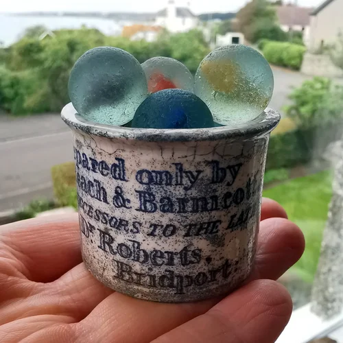 Sea glass finds held in a small cup