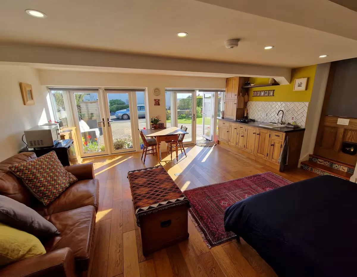 Low Tide studio living area with doors opening to the garden